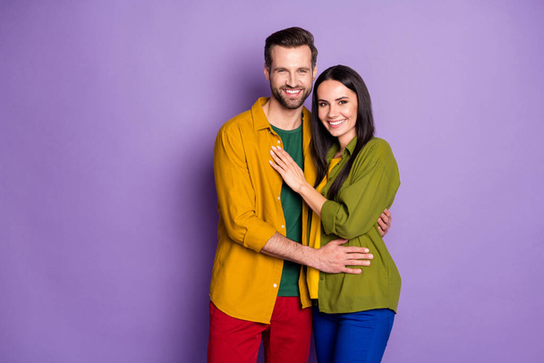 Photo pretty lady handsome guy couple hugging holding hands ignore social distancing good mood wear casual shirts clothes isolated purple color background - Foto, Bild