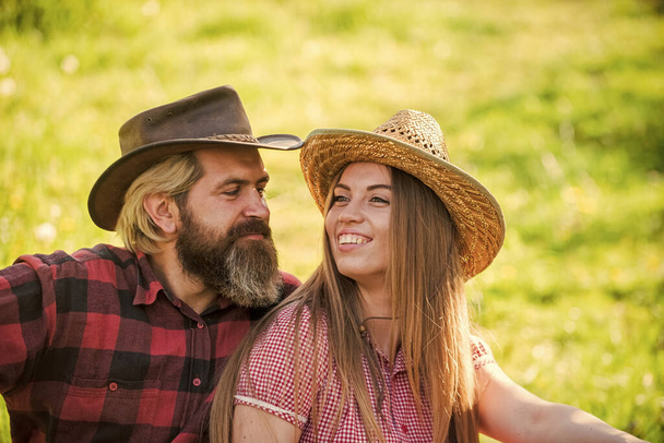 Romantic attraction. Sexy woman and bearded man enjoy romantic relationship. Romantic appeal. Sensual girl and hipster relax on green grass. Couple in love. Romantic vacation. Weekend getaway - Foto, imagen