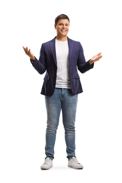 Full length portrait of a happy young man in jeans and suit gesturing with hands isolated on white background - Foto, Imagem
