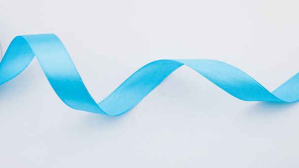closeup of blue ribbon on white background. - Foto, Bild