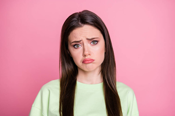 Closeup photo of offended depressed lady straight long hairdo look moody disappointed facial expression wear casual green sweatshirt pullover isolated pink pastel color background - Foto, immagini