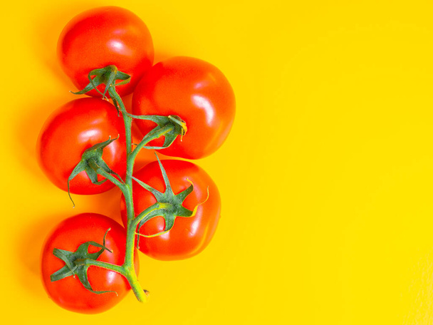 Healthy and dieting concept. Red tomatoes isolated on yellow color studio background with copy space. Flat lay, view from top. - Foto, Imagen