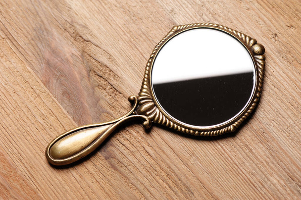 vintage style of women hand mirror on wooden desk - Photo, Image