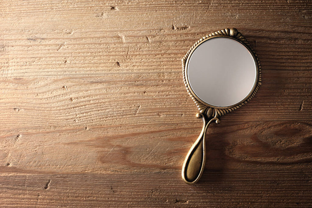 vintage style of women hand mirror on wooden desk - Photo, Image