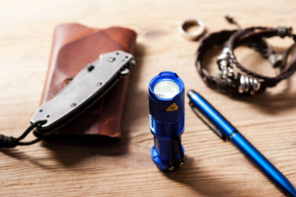 blue anodised aluminium pocket LED flashlight for Everyday Carry (EDC), shallow depth of field - Φωτογραφία, εικόνα