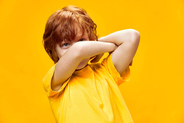 funny redhead boy holding crossed hands in front of face  - Fotoğraf, Görsel