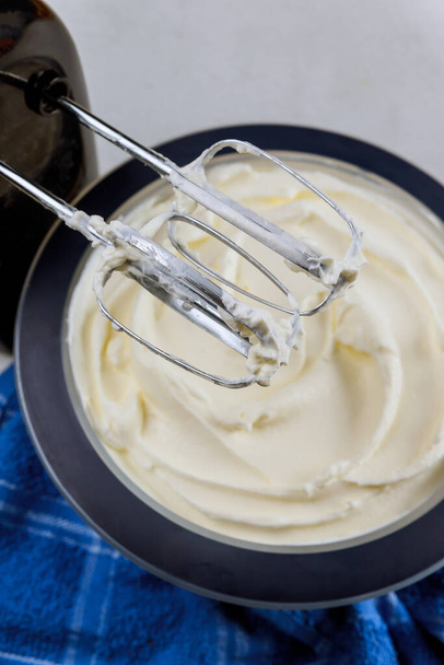 White cream for cake in bowl and mixer. Close up. - Photo, Image