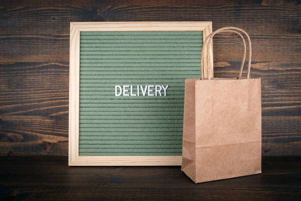 DELIVERY. Business concept. Green Felt Letter Board and a paper bag - Photo, Image