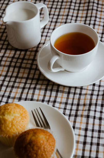 A Cup of Tea, Milk and Butter Cup Cake for Tea Break. - 写真・画像