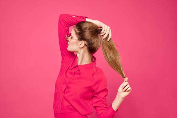 Woman in pink shirt and brown glasses cropped view fashion model emotions gesturing hands portrait - 写真・画像