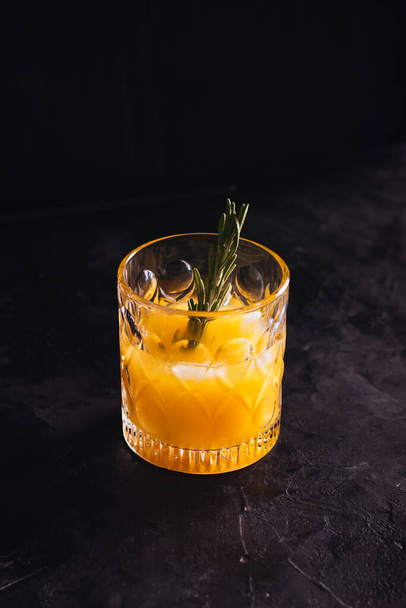 Orange juice with rosemary in a glass - Φωτογραφία, εικόνα