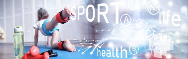 Sport and healthy lifestyle.Child playing sports at home. Yoga mat dumbbell and jump rope. Sports background with home exercises concept. - Photo, Image