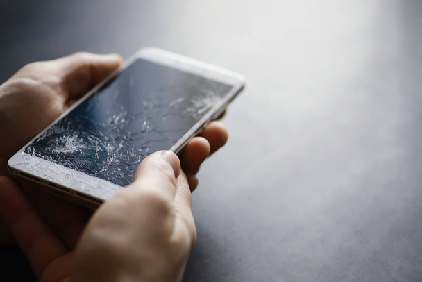Smartphone with a broken touch screen. Mobile phone broken. The phone crashed. Replacing broken glass on a cell phone. Smartphone repair. - Фото, зображення