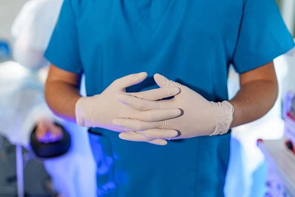 Doctor wearing protective latex gloves. Front view of man's hands. Health care concept. Selective focus. - Valokuva, kuva