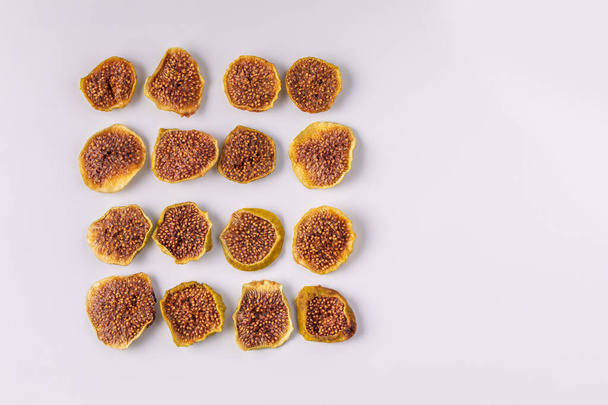 slices of dried figs on a white background. dried fruits. eco. top view. delicacy. - Valokuva, kuva