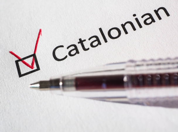 Questionnaire. Red pen and the inscription CATALONIAN with check mark on the white paper. Close-up background. High-quality macro photography. - Photo, Image