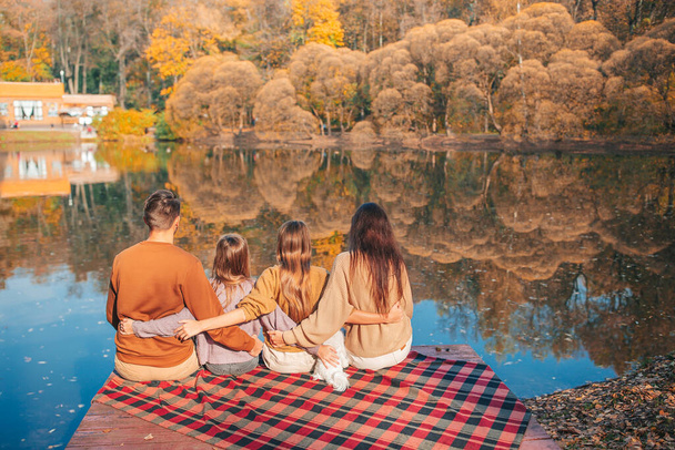 Beautiful family at autumn warm day near lake - Valokuva, kuva