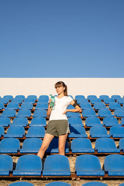 Healthy lifestyle concept. Teenage doing sports alone at the empty stadium - Photo, Image