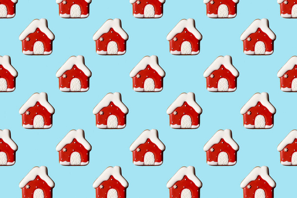 Creative Christmas pattern with red houses on pastel blue background, copy space. Minimal, winter, new year concept. Top view, flat lay - Foto, Bild
