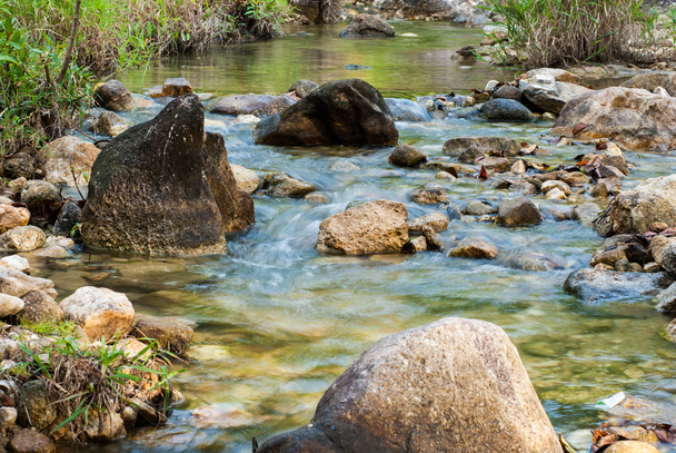 Stream flows through small rocks - Foto, Imagen