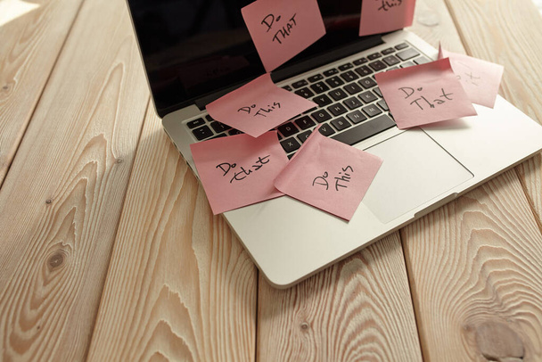 Image of laptop full of sticky notes reminders on screen. Work overload concept image. Coworking or working at home concept image. - Photo, Image