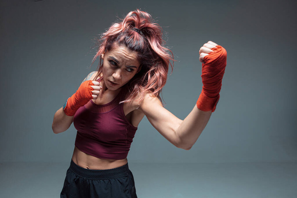 Large portrait of a female mixed martial arts fighter with a bandage on his hands - 写真・画像