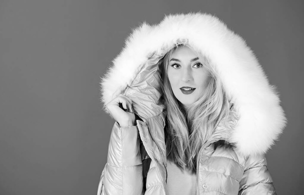 Cool and sexy. happy winter holidays. New year. beauty in winter clothing. cold season shopping. girl in hood. faux fur fashion. flu and cold. seasonal fashion. woman in padded warm coat - Foto, imagen