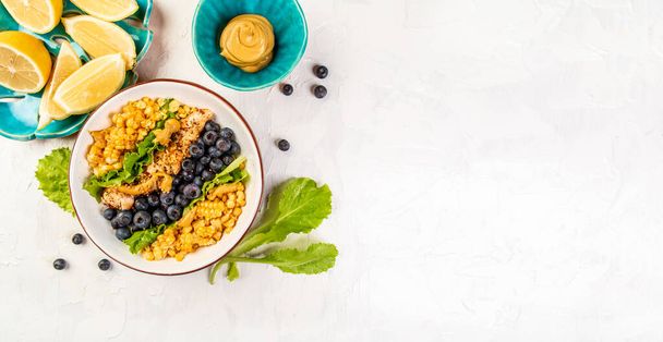 Ketogenic diet breakfast. Chicken salad with corn, lemon, mustard blueberries. Keto paleo lunch. Top view. Long banner format. space for text. - Photo, Image
