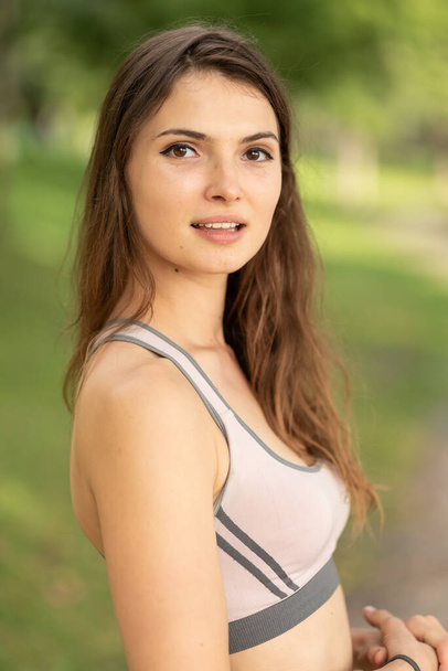 Portrait of a beautiful young sporty brunette girl - 写真・画像