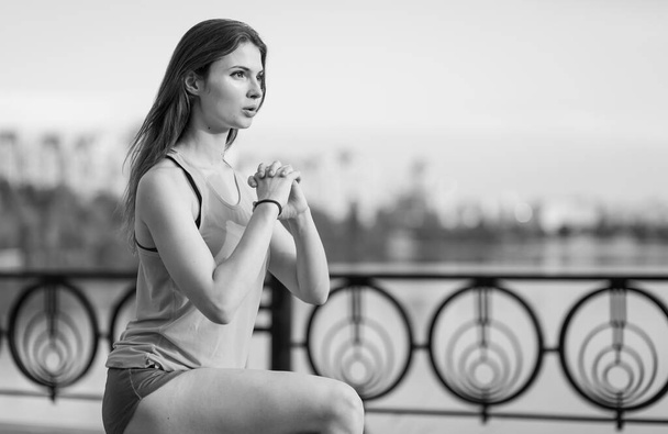Sports and healthy lifestyle : Brunette girl doing sports exercises. Black and white photo. BW - Fotografie, Obrázek