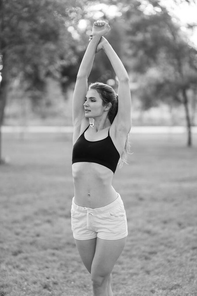 Portrait of a beautiful young sporty brunette girl. Black and white photo. BW - Fotó, kép