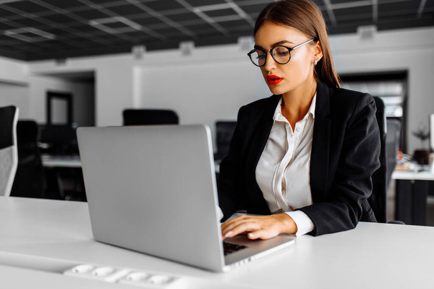 young business woman working with laptop in her office, business concept - Photo, image