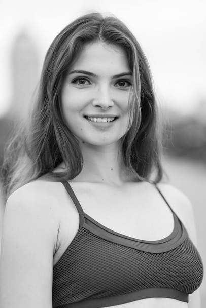 Portrait of a beautiful young sporty brunette girl. Black and white photo. BW - Foto, imagen