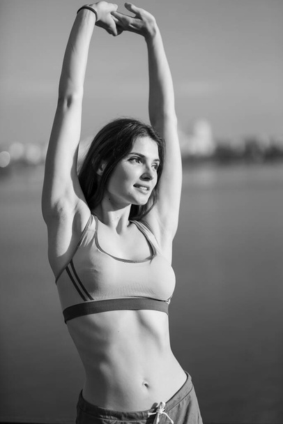 Portrait of a beautiful young sporty brunette girl. Black and white photo. BW - Φωτογραφία, εικόνα