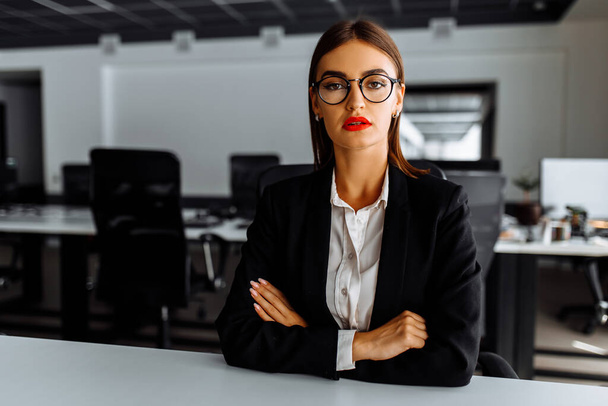 Attractive young business woman sitting at work table in office, business, success concept - Foto, Imagem