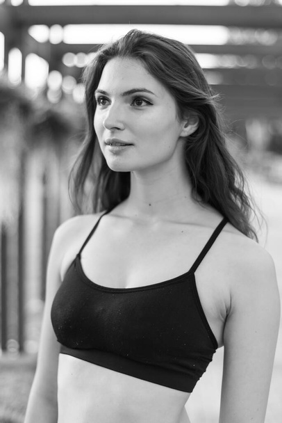 Portrait of a beautiful young sporty brunette girl. Black and white photo. BW - Fotoğraf, Görsel
