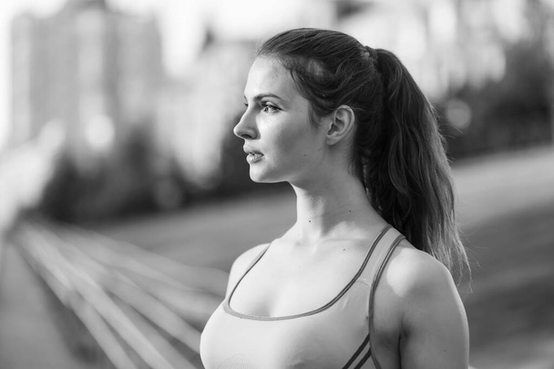 Portrait of a beautiful young sporty brunette girl. Black and white photo. BW - Photo, image