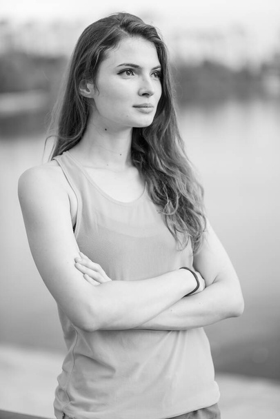 Portrait of a beautiful young sporty brunette girl. Black and white photo. BW - Fotografie, Obrázek