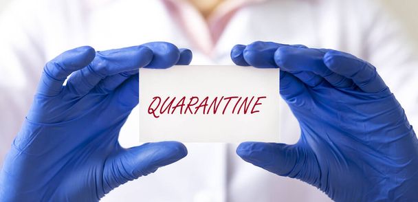 word QUARANTINE close up on paper in hands of doctor in protective gloves, banner - Foto, immagini