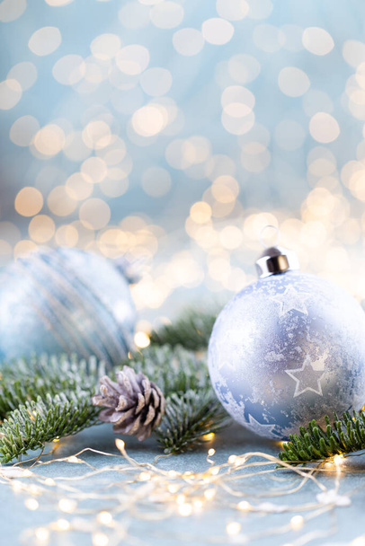 Christmas spruce with ball and blurred shiny lights. - Zdjęcie, obraz