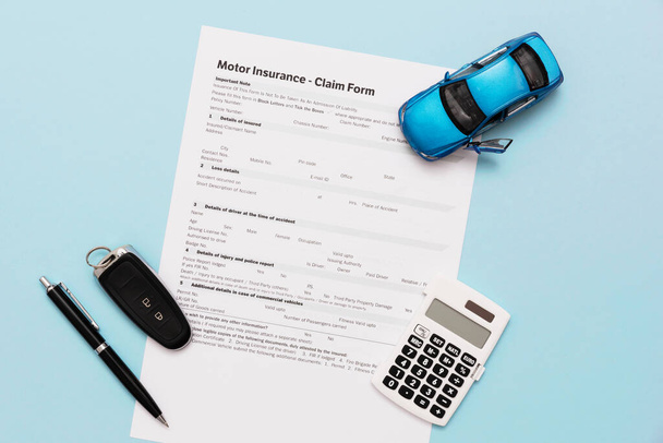 Car insurance, insurance contract and car keys on a blue background - Фото, изображение