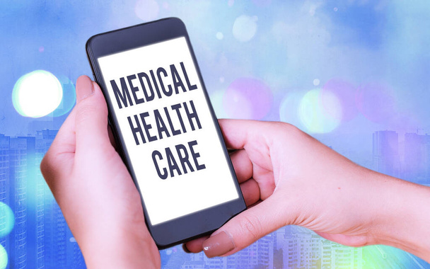 Word writing text Medical Health Care. Business concept for restoration of our physical and mental wellbeing Modern gadgets with white display screen under colorful bokeh background. - Photo, Image