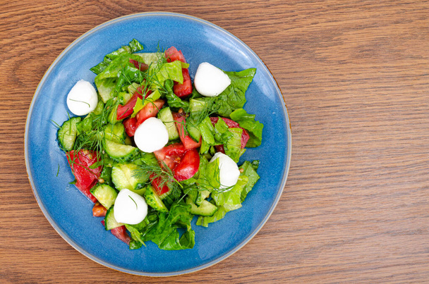 Fresh vegetable salad with mozzarella balls. Studio Photo - Photo, Image