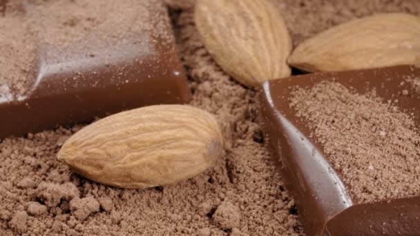 Шоколад и миндаль в какао порошок крупным планом. Экстремальный макрос. - Кадры, видео