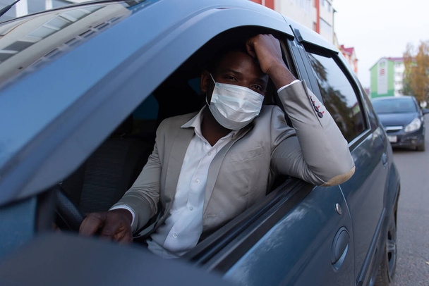the African American in protective mask in car - Photo, Image