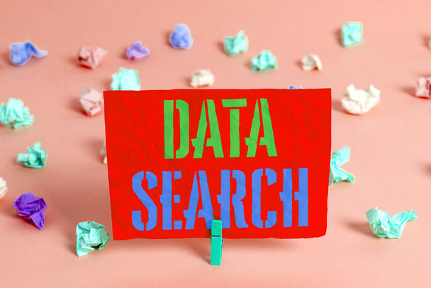 Text sign showing Data Search. Conceptual photo gathers and reports information contains specified terms Colored crumpled rectangle shaped reminder paper light blue background. - Photo, Image