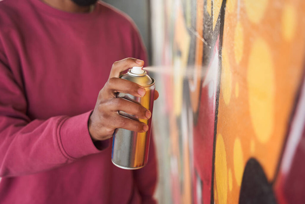 Man pulverizing paint from the aerosol - Photo, image