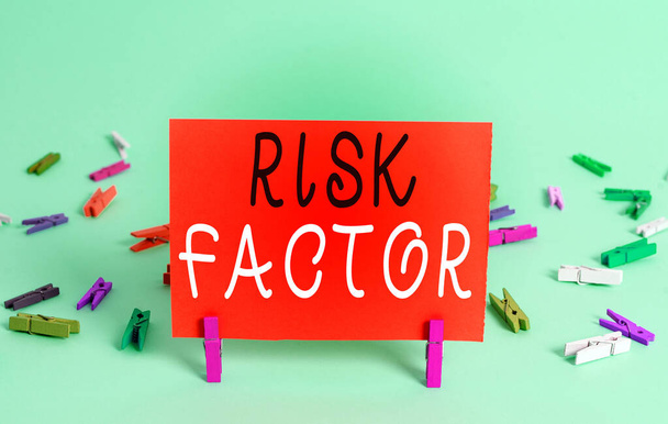 Text sign showing Risk Factor. Conceptual photo Characteristic that may increase the percentage of acquiring a disease Colored crumpled rectangle shaped reminder paper light blue background. - Photo, Image