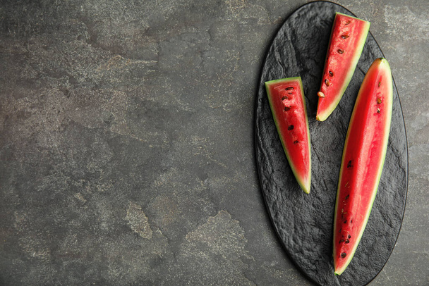 Yummy watermelon slices on grey table, top view. Space for text - Фото, зображення
