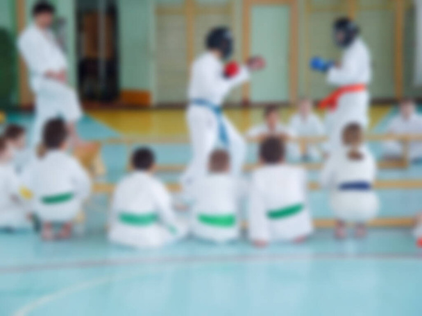 Defocused photography. Kids training on karate. Blurred background with copy space for your design. - Photo, Image